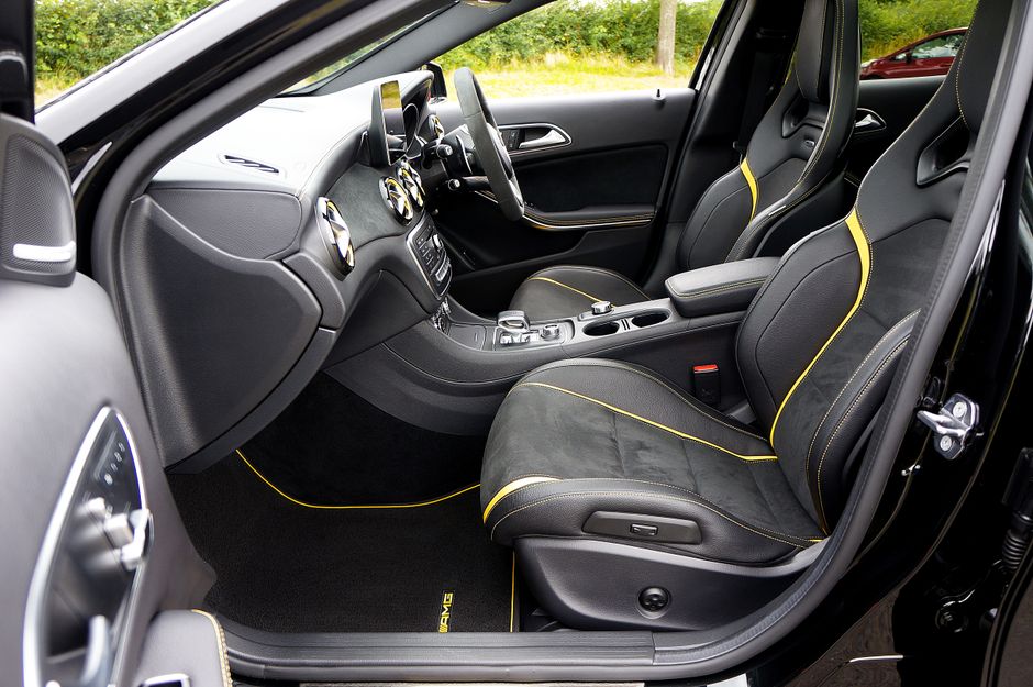 Explore a sleek luxury car interior featuring sporty leather seats and detailed craftsmanship.